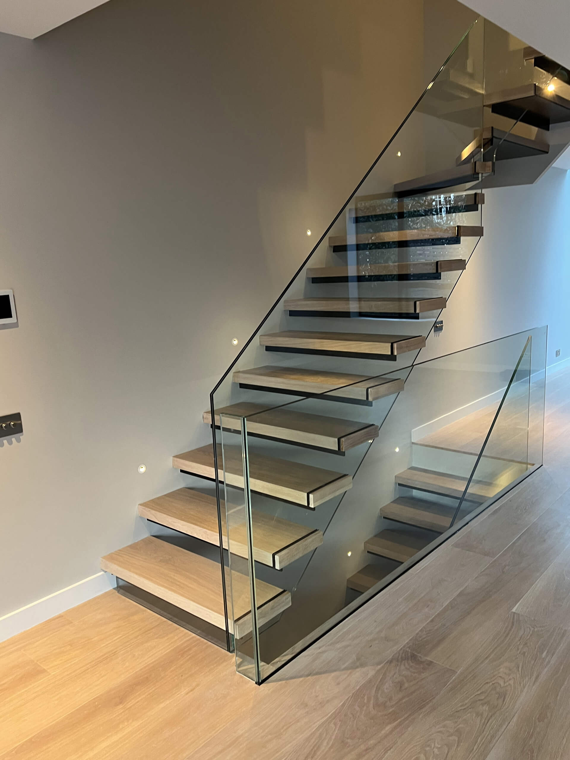 Floating Staircase With Frameless Glass Balustrade And Light Brown Oak Treads 3